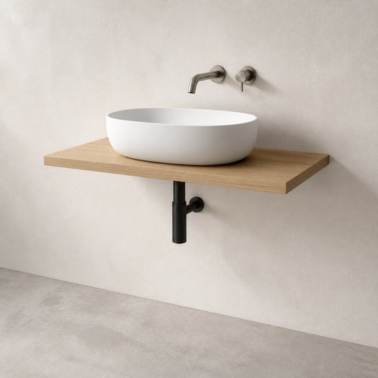A modern wall-mounted floating vanity shelf in light natural wood, holding a white oval vessel sink with a matte black wall-mounted faucet and pipe.