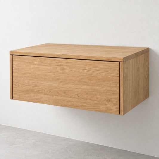 A modern wall-mounted floating cabinet with a light oak wood grain finish, shown against a neutral off-white wall and gray floor.