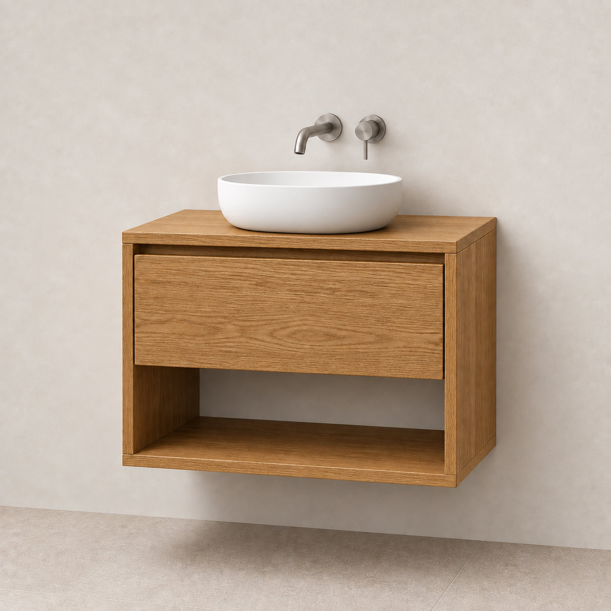 A modern floating bathroom vanity made of oak wood, featuring a single drawer and open lower shelf, with a white oval vessel sink and brushed metal faucet mounted on a light beige textured wall.