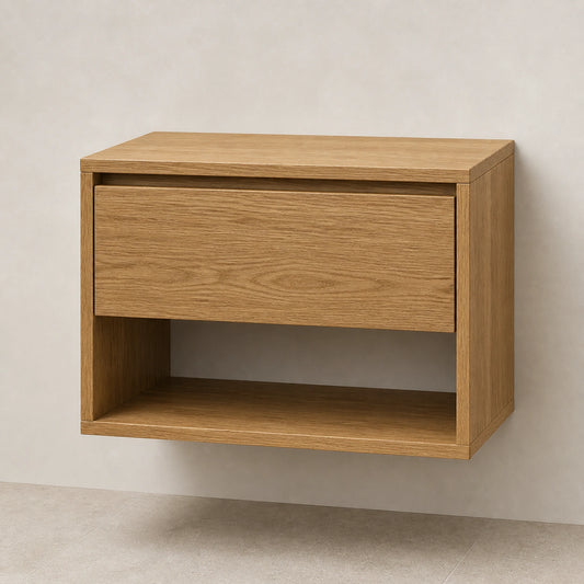 A modern floating nightstand with a single drawer and open lower shelf, made of light oak wood, shown against a neutral textured wall.