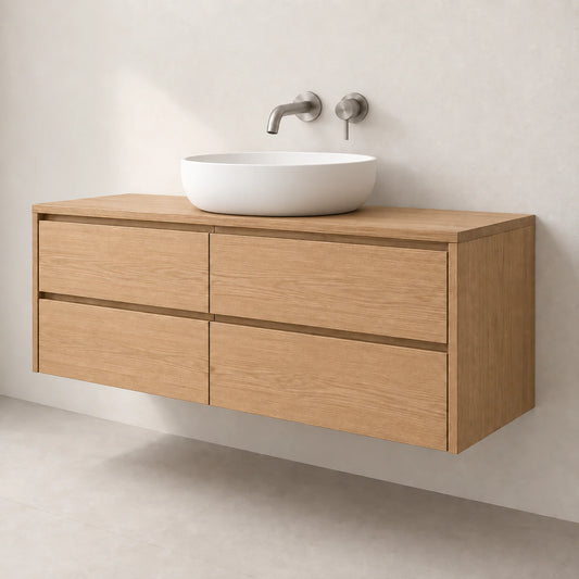 A modern floating bathroom vanity in light oak wood with four drawers, topped with a white ceramic vessel sink and a matte metal wall-mounted faucet.